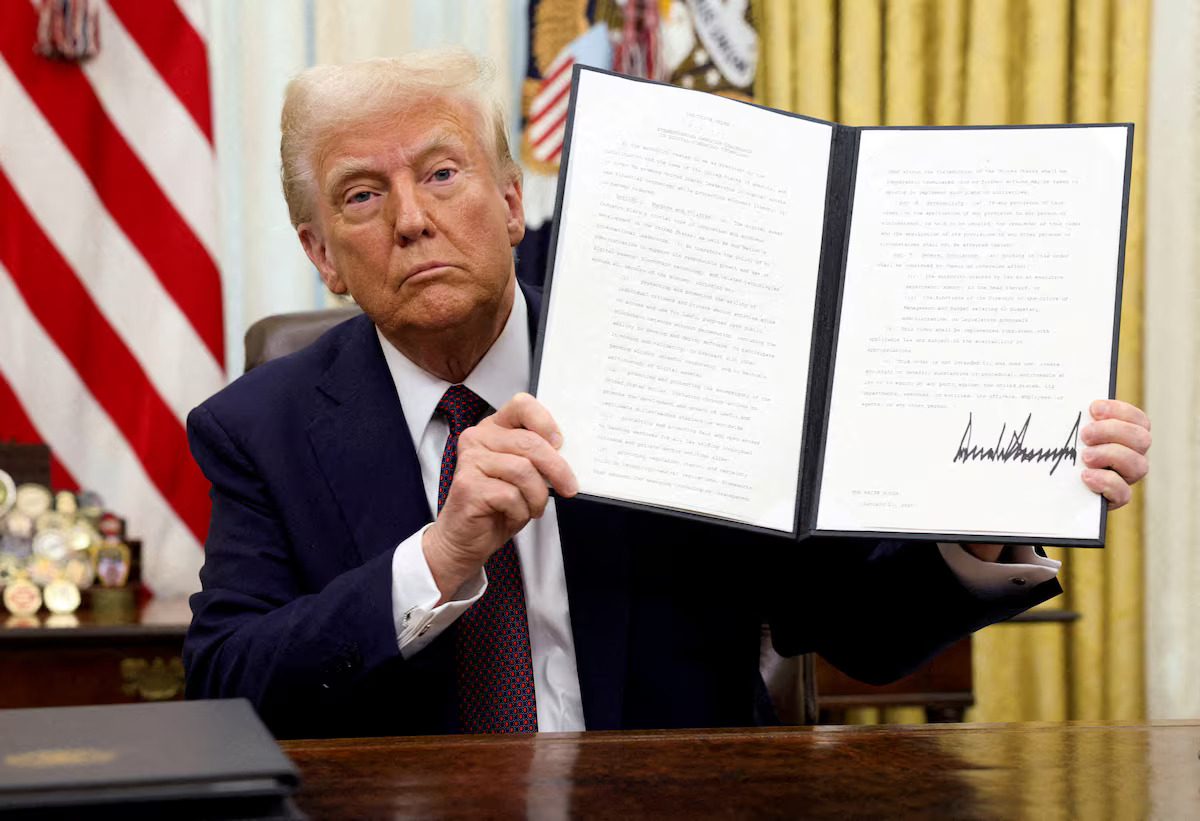 U.S. President Donald Trump holds a signed executive order on cryptocurrencies, in the Oval Office of the White House, in Washington, U.S., January 23, 2025